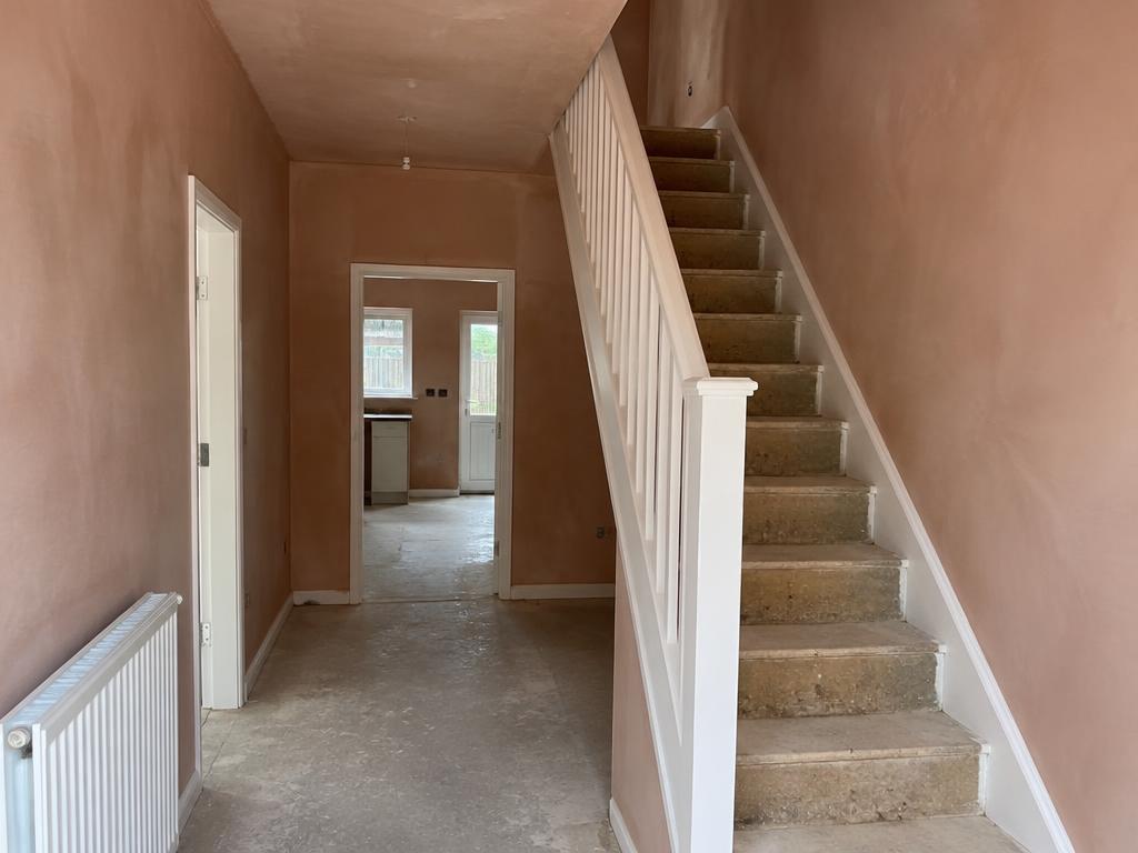 Hallway and staircase with freshly plastered walls